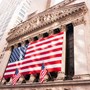 Large American flag on pillars of a building on New York's Wall Street